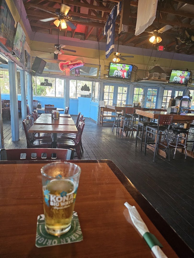 Sports screens above tables and booths.
